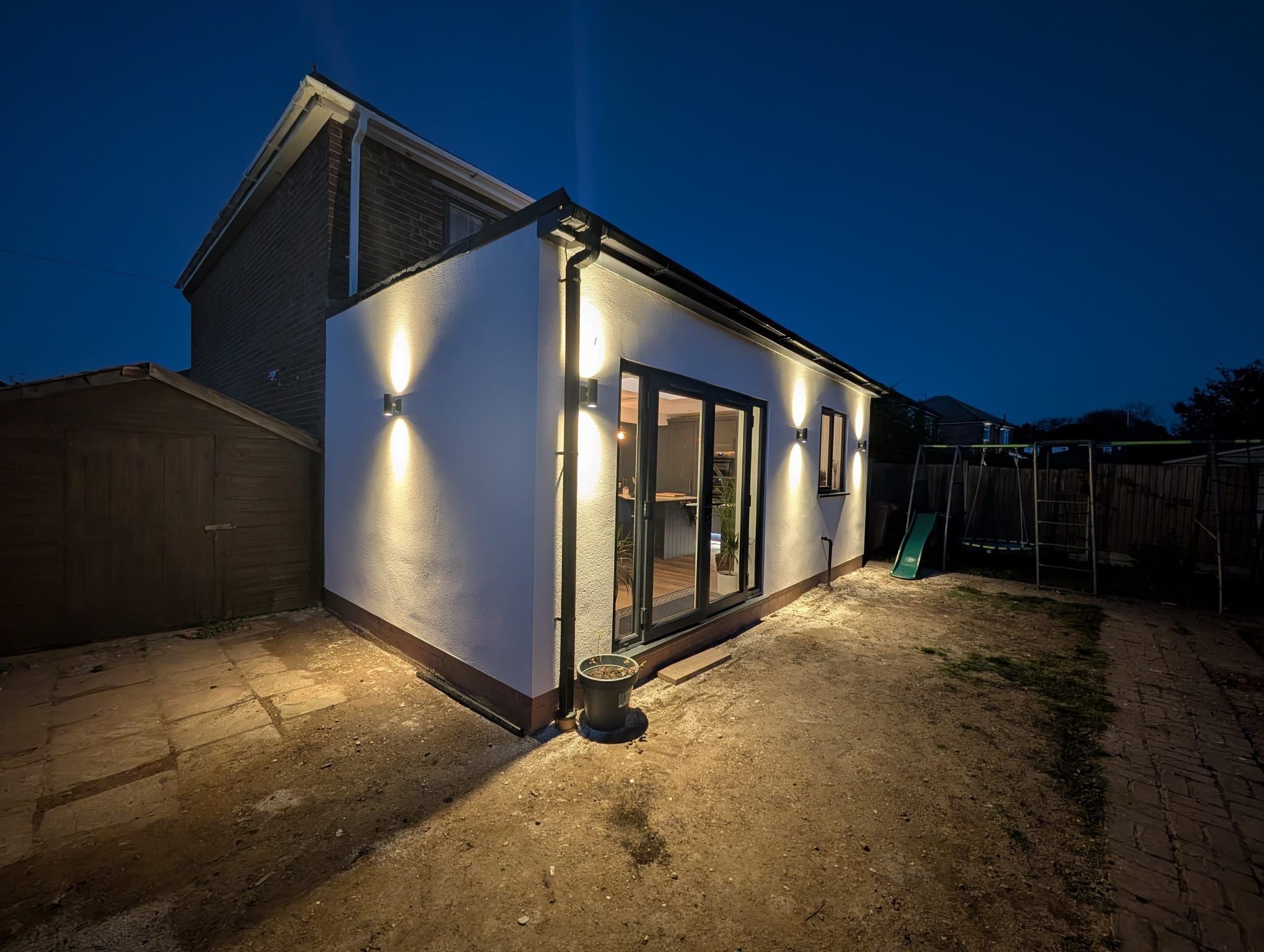 Back extension night view completed in Lincoln by Tudor Roofing and Building.