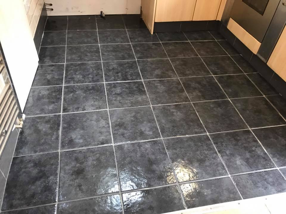 Dark ceramic kitchen tiling in Lincolnshire showing newly installed floor tiles during renovation